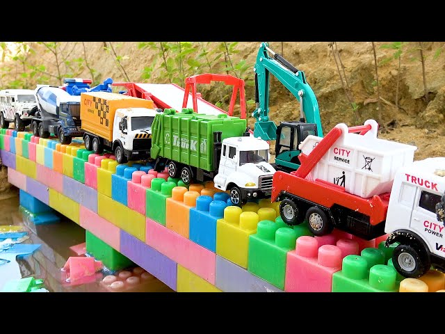 Crane pulls the truck out of the water, and Bibo and dump truck assemble the bridge.