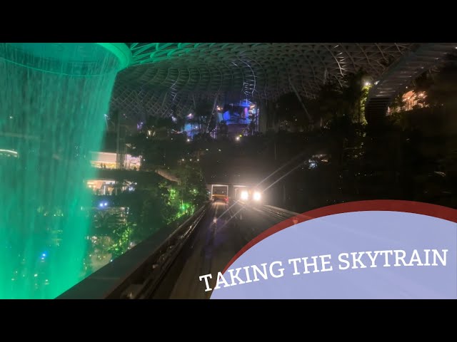 Taking the SKYTRAIN in Changi Airport from T2 to T3!