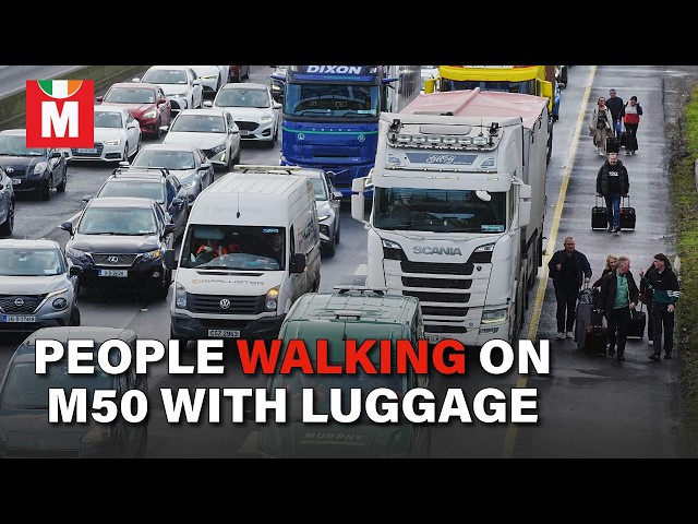 People Walking with Luggage on M50 Near Dublin as Fuel Protest Brings Traffic to Halt