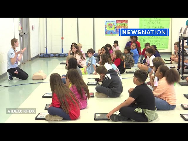 Elementary students practice real time CPR with guided technology
