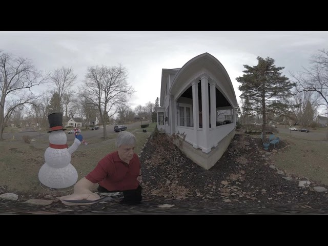 Kids playing around Frosty the snowman