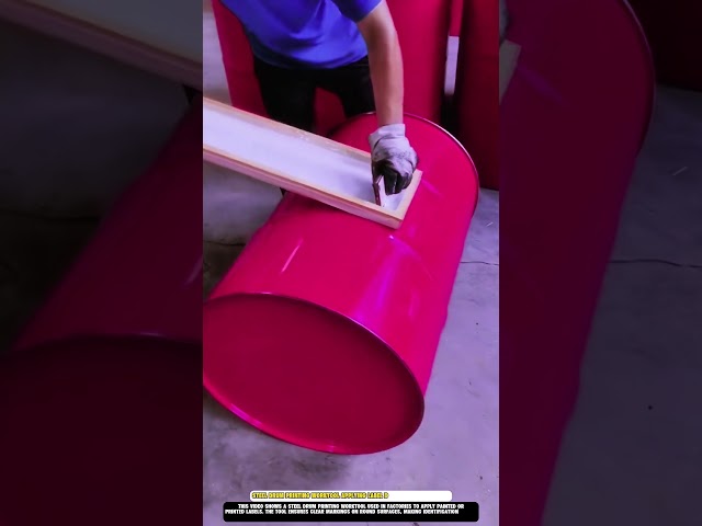Steel drum printing Worktool applying label designs in factory use